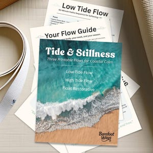 May include: A collection of yoga-related items, including a rolled-up yoga mat, a cork block, and printed guides. The central guide is titled "Tide & Stillness" with ocean imagery and flow descriptions. A seashell rests on the surface.