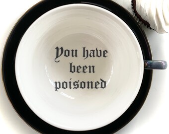 Imperfections - Black and Gold “You have been Poisoned” Cup and Saucer Set, 16 Ounces, Porcelain