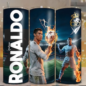 May include: A stainless steel tumbler featuring a design with the name "RONALDO" in large white letters. The tumbler showcases images of a soccer player in action, with flames and stadium backgrounds. The design includes the "CR7" logo.