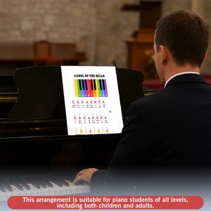 May include: A sheet music arrangement for "Carol of the Bells" displayed on a piano music stand. The sheet music features a colorful keyboard diagram and musical notation. The text on the sheet music reads "CAROL OF THE BELLS".