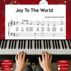 Puede incluir: Una partitura de piano titulada Joy To The World de George Frederick Handel, que presenta notación musical con notas con letras y letras de canciones. La partitura se coloca sobre un teclado de piano blanco y negro con manos.