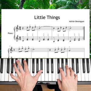 May include: A sheet music page titled Little Things by Adrián Berenguer featuring a piano staff with a 3/4 time signature, musical notes, and finger numbering, positioned above a piano keyboard with black and white keys.