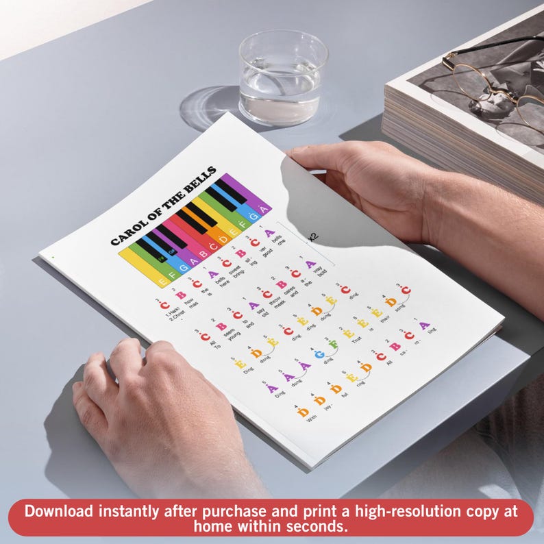 May include: A sheet music printout of "Carol of the Bells" with a colorful piano keyboard graphic at the top. The text includes musical notes and lyrics. The bottom of the image has the text: "Download instantly after purchase and print a high-resolution copy at home within seconds."
