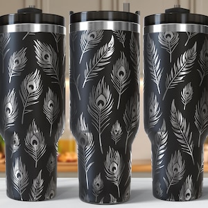 May include: Three black travel mugs with a silver peacock feather pattern. Each mug has a black handle and lid. The mugs are approximately 9 inches tall and are designed to keep beverages hot or cold.