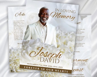 May include: A memorial card featuring a photograph of a smiling man in a white suit, set against a backdrop of white roses. The card displays the words "In Loving Memory", the name "Joseph David", and the dates "November 17th, 1958-April 19th, 2023."