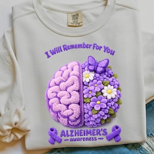 May include: Cream-coloured sweatshirt featuring a purple brain and floral design. The text "I Will Remember For You" and "Alzheimer's - awareness" are embroidered in purple. A purple ribbon is also featured.