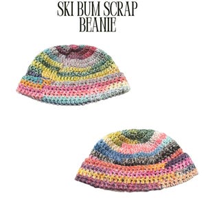 May include: Two colorful, crocheted beanies. The beanies are made with a variety of yarn colors, including pink, yellow, blue, and green. The text "SKI BUM SCRAP BEANIE" is above the beanies.