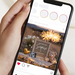 May include: A smartphone screen shows a pregnancy announcement. The announcement includes a letter board with the word "Surprise", a teddy bear, a sonogram, and a gold heart. The background features fireworks and flowers.