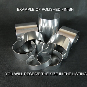 May include: Example of a polished finish on a set of silver metal bracelets. You will receive the size in the listing.