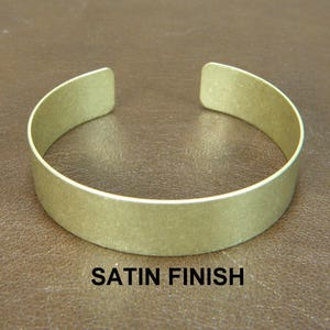 May include: A satin finish brass bangle bracelet.
