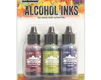 May include: A set of three 0.5 fluid ounce bottles of Adirondack Alcohol Inks in the colors Cranberry, Lettuce, and Eggplant. The bottles are packaged on a colorful card with the product name and brand.