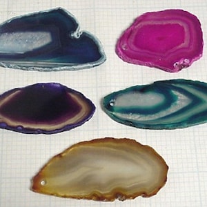 May include: Five agate slices in various colors and patterns. The slices are all about 3 inches in diameter and have a natural, polished finish.