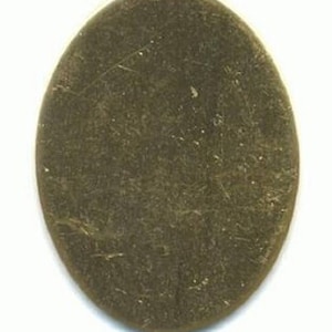 May include: A blank oval-shaped metal charm, perfect for adding a personalized touch to jewelry or crafts.