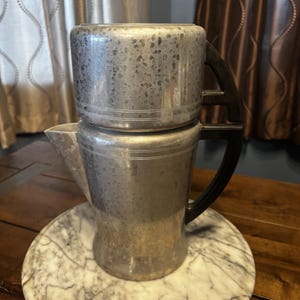 May include: A rustic wooden sign with the text "Welcome to our home" in white lettering. The sign features a distressed finish and a simple, inviting design, perfect for a front porch or entryway.