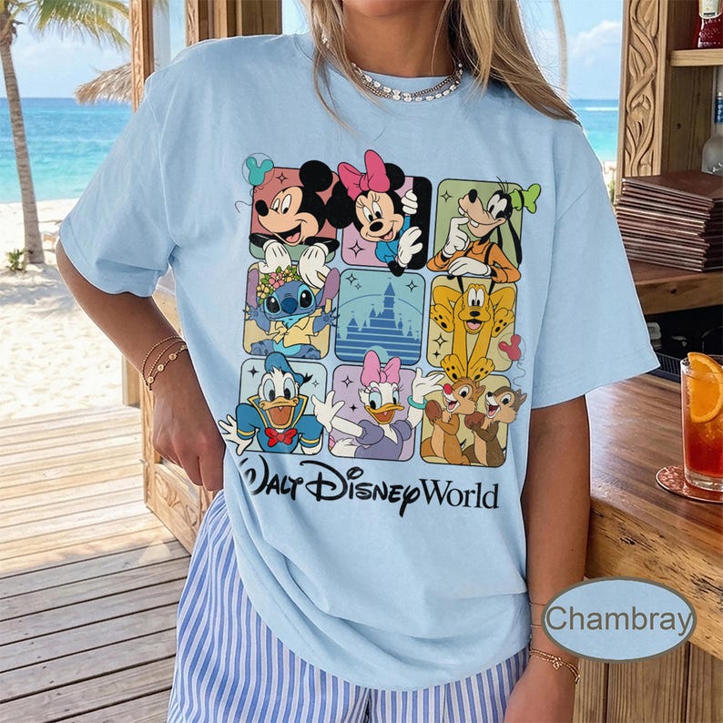May include: Light blue t-shirt featuring a grid of Disney characters including Mickey Mouse, Minnie Mouse, Goofy, Stitch, Donald Duck, Daisy Duck, Pluto, and Chip and Dale. The words "Walt Disney World" are printed below the grid.