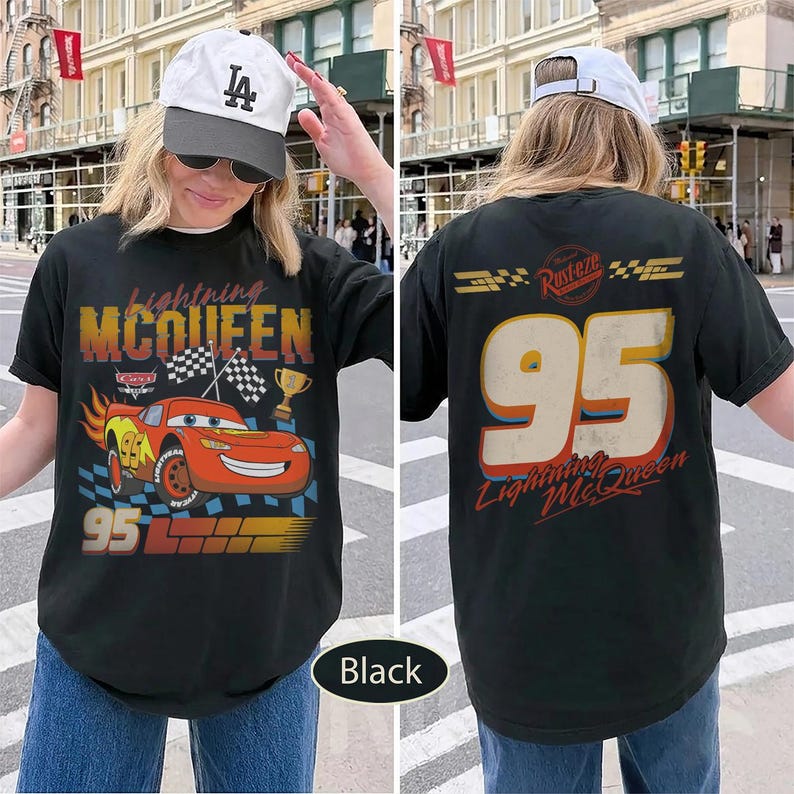 May include: Black t-shirt featuring Lightning McQueen from the Cars movie. The front design includes the character, the number 95, and the text "Lightning McQueen." The back displays the number 95 and the text "Lightning McQueen."