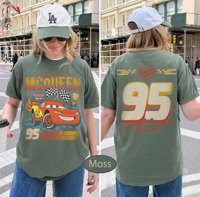 May include: Moss green t-shirt featuring a graphic of Lightning McQueen from the Cars movie. The front design includes the number 95, checkered flags, and a trophy. The back of the shirt displays the number 95 and the text "Lightning McQueen".