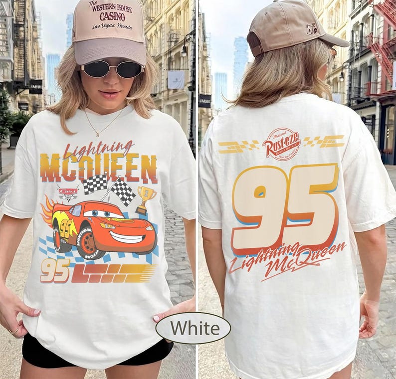 May include: White t-shirt featuring Lightning McQueen from the Cars movie. The front graphic includes the character, the number 95, and the text "Lightning McQueen". The back displays "95" and "Lightning McQueen".