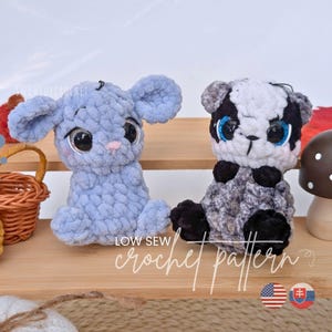 May include: Two plush crochet toys, one light blue and one black, white, and gray, featuring large glossy eyes and small ears. The text "LOW SEW crochet pattern" is visible in white script. The toys are displayed on a wooden shelf.