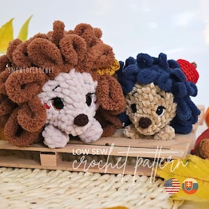 May include: Two handmade crochet dog toys. One dog has brown fur and the other has blue fur. The toys are on a wooden pallet with fall leaves. The text "LOW SEW crochet pattern" is visible.