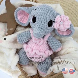 May include: A handmade gray elephant plush toy with pink accents, wearing a pink dress and a flower on its ear. The elephant is crocheted and has black eyes. The text "LOW SEW CROCHET PATTERN" is visible.