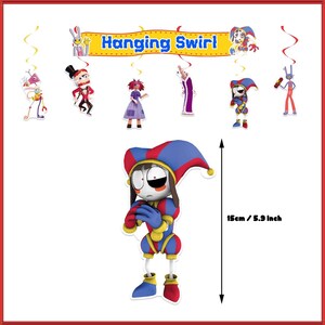May include: A set of hanging swirl decorations featuring various cartoon characters and a banner with the text Hanging Swirl. A central jester character is shown with a height measurement of 5.9 inches indicated by a double-sided arrow.