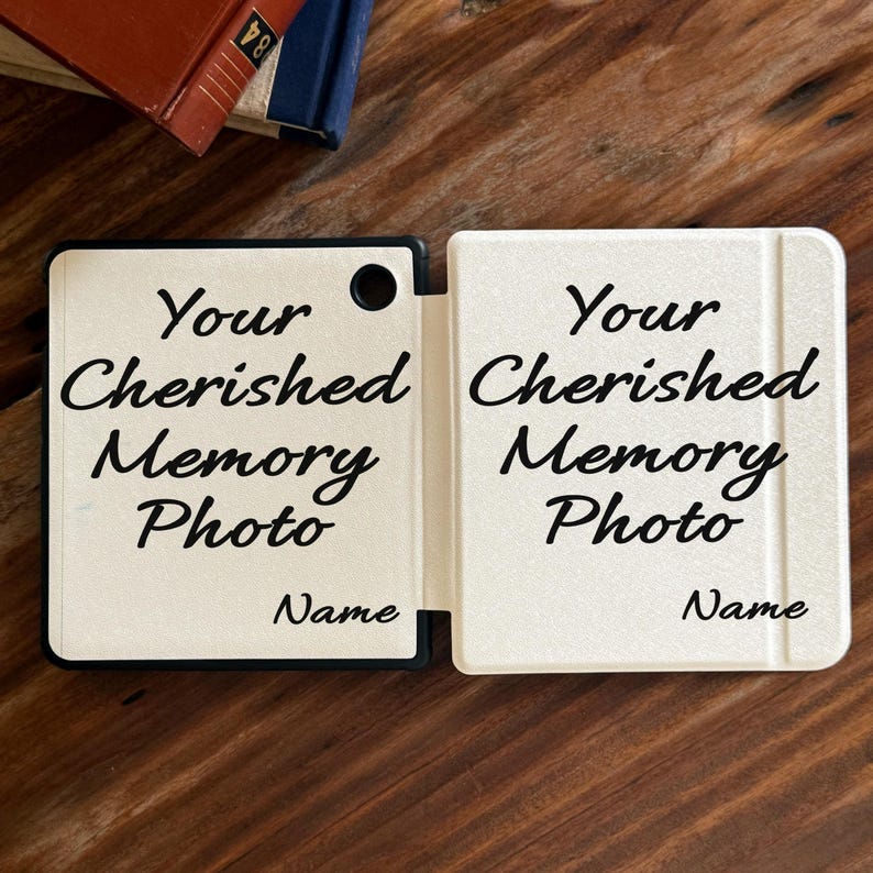May include: A white, rectangular, folding photo frame with a black border and a circular cutout. The text "Your Cherished Memory Photo" is printed in black script, followed by the word "Name" in the bottom right corner of each panel.
