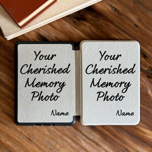 May include: A rectangular, light-coloured, foldable photo frame with a textured surface. The front panels feature the black printed text Your Cherished Memory Photo and Name on both sides, designed to hold two separate photographs.