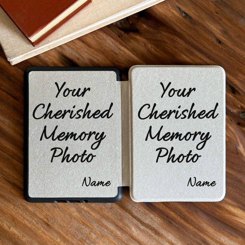 May include: A rectangular, light-coloured, foldable photo frame with a textured surface. The front panels feature the black printed text Your Cherished Memory Photo and Name on both sides, designed to hold two separate photographs.
