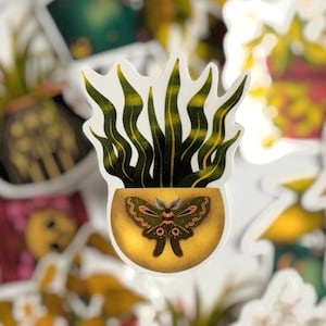 May include: A selection of stickers with botanical illustrations. The main sticker shows a potted plant with long, green leaves and a moth design on the pot. Other stickers depict various plants and floral arrangements in pots, against a white backdrop.
