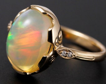 Welo Opal Ring, 10 x 13 mm  3.67 carat 14k yellow gold ring, bezel set, leaf accents with diamonds