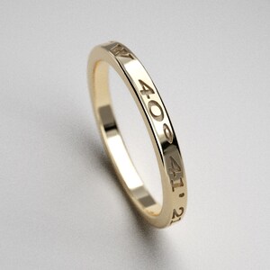 May include: A gold band ring with the numbers 40, 41, and 21 engraved on the side.