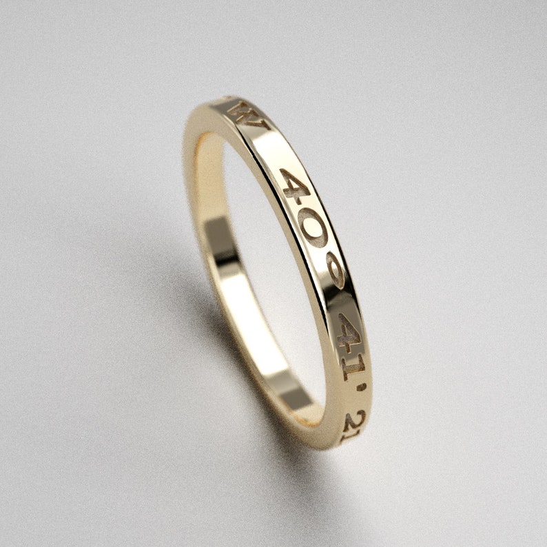 May include: A gold band ring with the numbers 40, 41, and 21 engraved on the side.