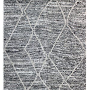 May include: A rectangular rug with a textured, grey and white design. The rug features a diamond pattern in a lighter shade of grey, creating a contrasting visual effect. The edges have a dark grey border.