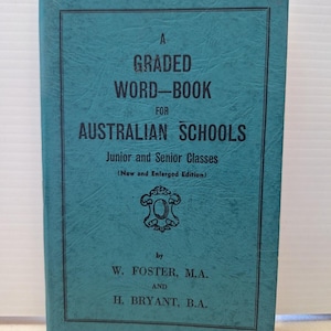 May include: A teal-coloured hardback book titled A GRADED WORD-BOOK FOR AUSTRALIAN SCHOOLS, Junior and Senior Classes (New and Enlarged Edition) by W. Foster, M.A. and H. Bryant, B.A. The cover features black text and a decorative emblem.