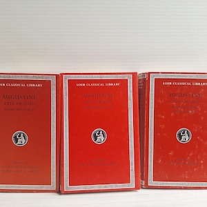 May include: Three red hardcover books from the Loeb Classical Library, each titled Augustine City of God. The covers feature white text, a central circular emblem, and a decorative border. The books are arranged side-by-side in a row.