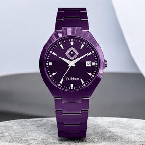 May include: A purple wristwatch with a matching strap. The watch face is dark purple with white hour markers, hands, and the brand name "Vallirium". The watch has a date display at the 3 o'clock position.