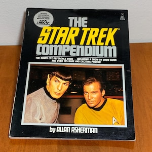 Puede incluir: Libro The Star Trek Compendium de Allan Asherman. La portada es negra con texto amarillo y blanco. El libro incluye una foto de Spock y el Capitán Kirk. Una guía de referencia completa con más de 125 fotos raras.