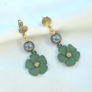 Beautiful gold earrings with green flower pendants and green-grey pearl beads.