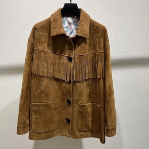 May include: A brown suede jacket with fringe detailing across the chest. The jacket has a collared neckline, two front pockets, and button closures. The interior lining features a colourful pattern.