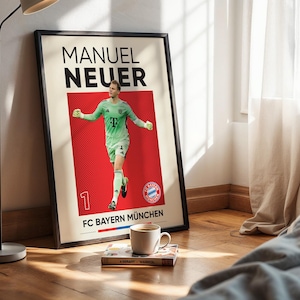 Pode incluir: Um cartaz emoldurado com um gr&aacute;fico de Manuel Neuer em uniforme de guarda-redes verde claro sobre um fundo vermelho. O texto diz MANUEL NEUER e FC BAYERN M&Uuml;NCHEN, com o n&uacute;mero 1 e o log&oacute;tipo da equipa FC Bayern M&uuml;nchen na impress&atilde;o.