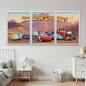 May include: A set of three framed art prints depicting characters from the animated film "Cars." The prints show various car characters in a desert setting, with the text "Welcome to Radiator Springs" in a stylized font.