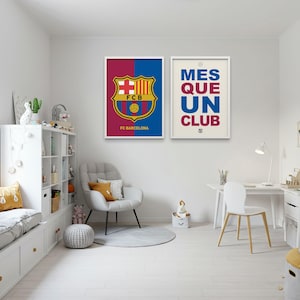 May include: Two framed posters with white borders. One features the FC Barcelona logo on a blue and maroon background, with "FC Barcelona" below. The other poster says "MES QUE UN CLUB" in blue and maroon text on a cream background.