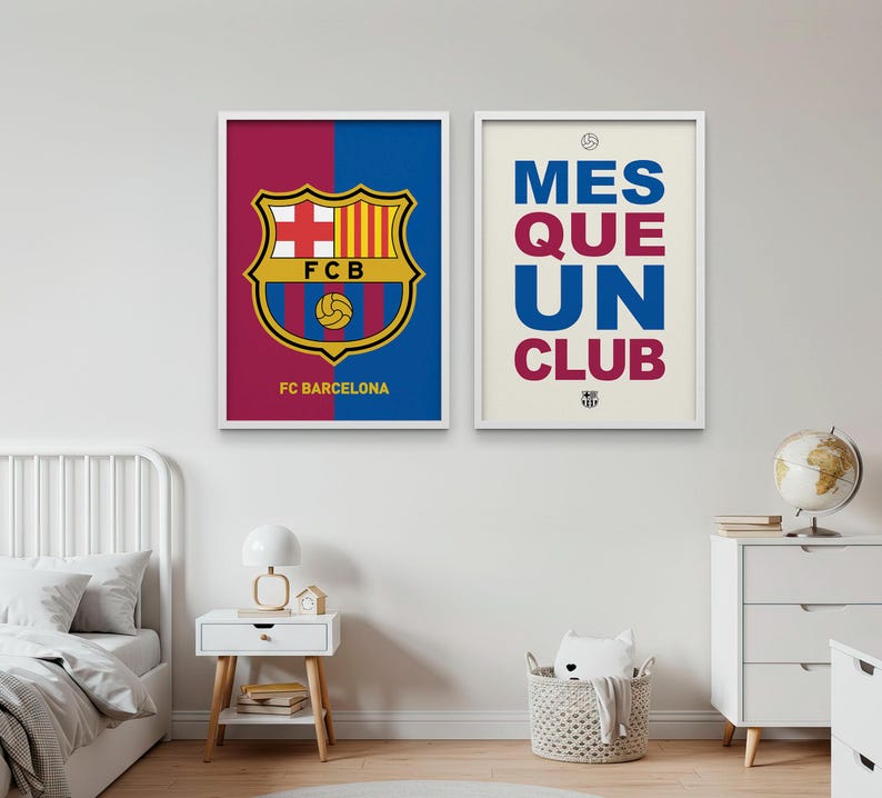 May include: Two framed posters featuring FC Barcelona imagery. One displays the team's crest with a red and blue background, the other reads "MES QUE UN CLUB" in blue and burgundy. Both are in white frames.