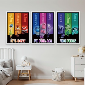 May include: Three framed art prints featuring characters from the film "Inside Out." Each print has a black border and a colourful background with the words "It's Okay," "To Feel All," and "The Feels."