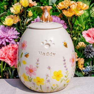 May include: A handmade wooden sign with the text "Welcome" in a playful font. The sign is painted white with a distressed finish, and features a decorative floral design in shades of pink and green. It is designed for indoor or outdoor use.