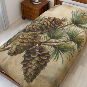 May include: A bedspread featuring a watercolor illustration of pine cones and needles on a branch. The design has a vintage aesthetic with a sepia-toned background. The pine cones are brown, and the needles are green.