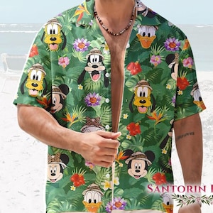 May include: Green Hawaiian shirt featuring cartoon characters like Mickey Mouse, Donald Duck, and Goofy, set against a backdrop of tropical foliage and flowers. The shirt has short sleeves and a relaxed fit, perfect for a casual, beachy vibe.