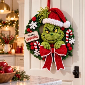 May include: A crocheted green character wreath featuring a red Santa hat with white trim, a large red bow, candy canes, and white snowflakes. A rectangular sign attached to the wreath displays the text Merry GRINCHMAS in black and red letters.