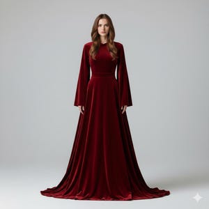 May include: A floor-length, burgundy velvet gown with long, flared sleeves. The dress features a fitted bodice and a flowing skirt that pools on the floor. The elegant design is suitable for formal events.